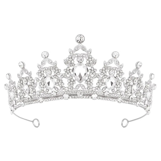A silver tiara crown with a intricate design and adorned with sparkling rhinestones.